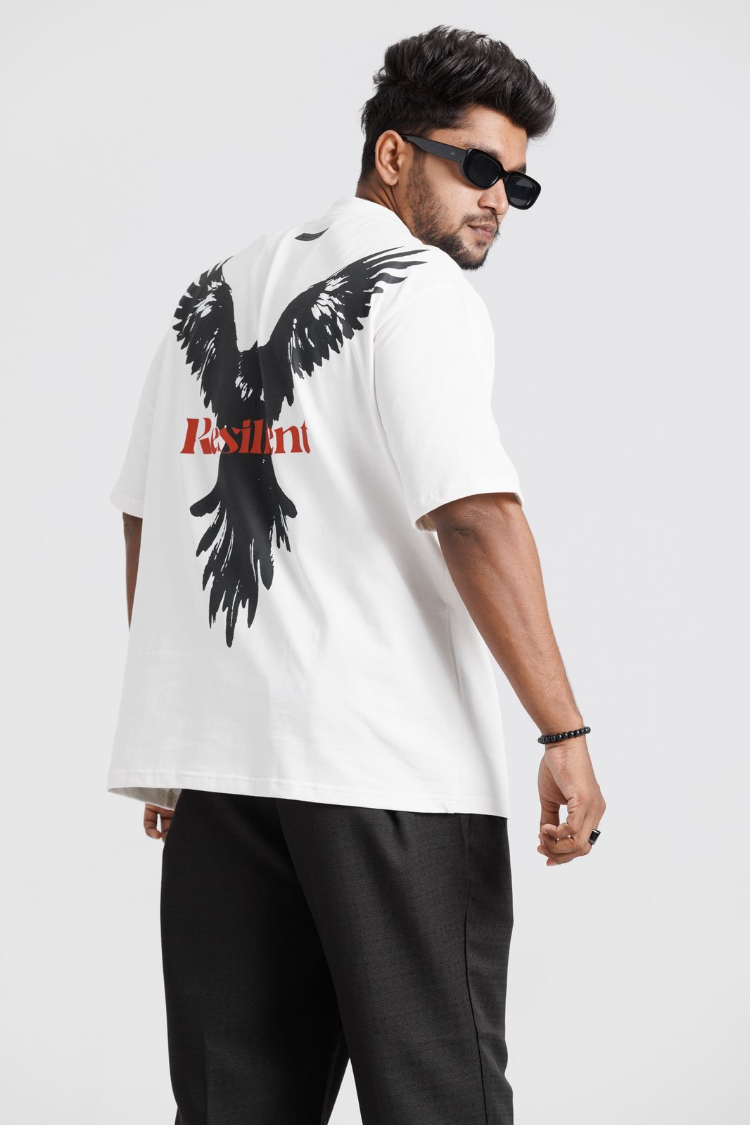 Man wearing a white t-shirt with a back print