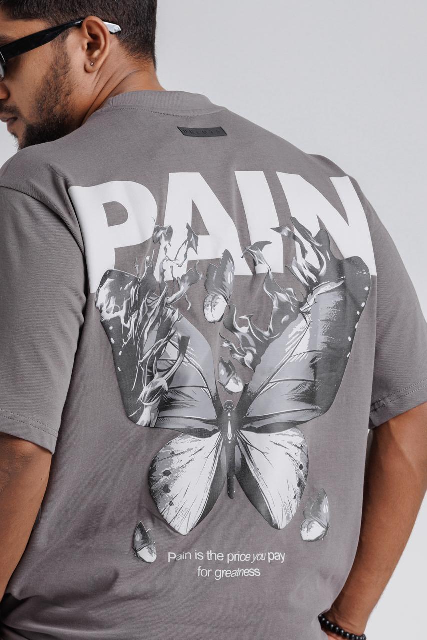 Person wearing a gray t-shirt with butterfly design and text on the back